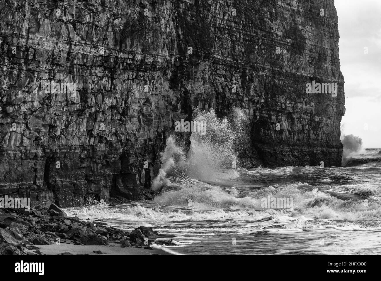 Winter storm whips waves and spray against the red sandstone rocks on the northern beach, High Sea Island Helgoland, North Sea, Pinneberg district Stock Photo