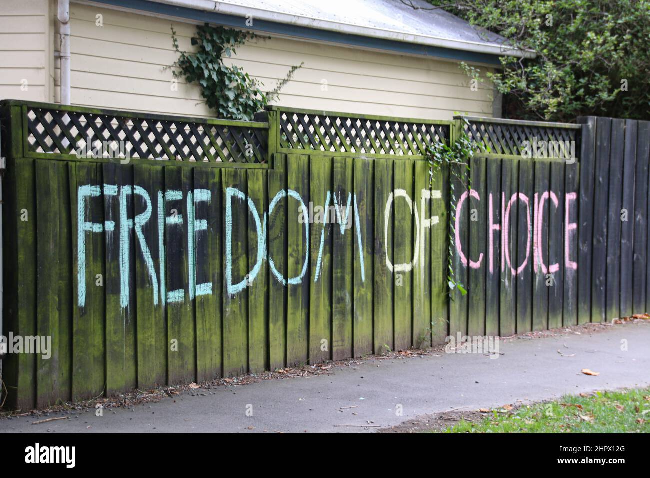 Christchurch, New Zealand. 23rd Feb, 2022. 'Freedom of choice' is written on a fence of a residential house. Covid-19 cases are rising very rapidly across New Zealand. The BA2 variant of Omicron has been detected around with Delta also being detected in genomically sequenced tests. (Photo by Adam Bradley/SOPA Images/Sipa USA) Credit: Sipa USA/Alamy Live News Stock Photo