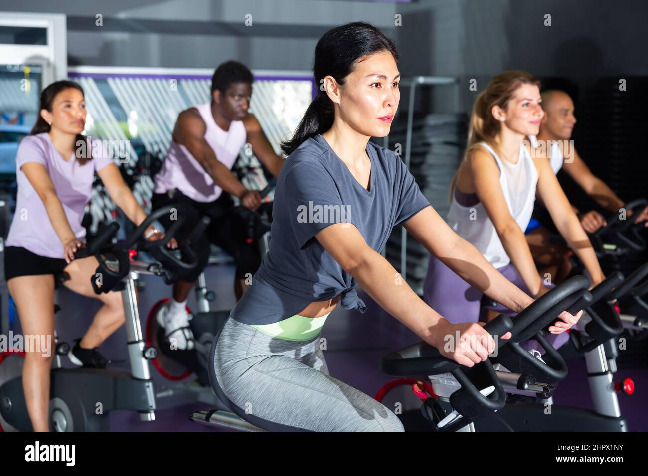 Woman ride stationary bike in fitness club Stock Photo Alamy
