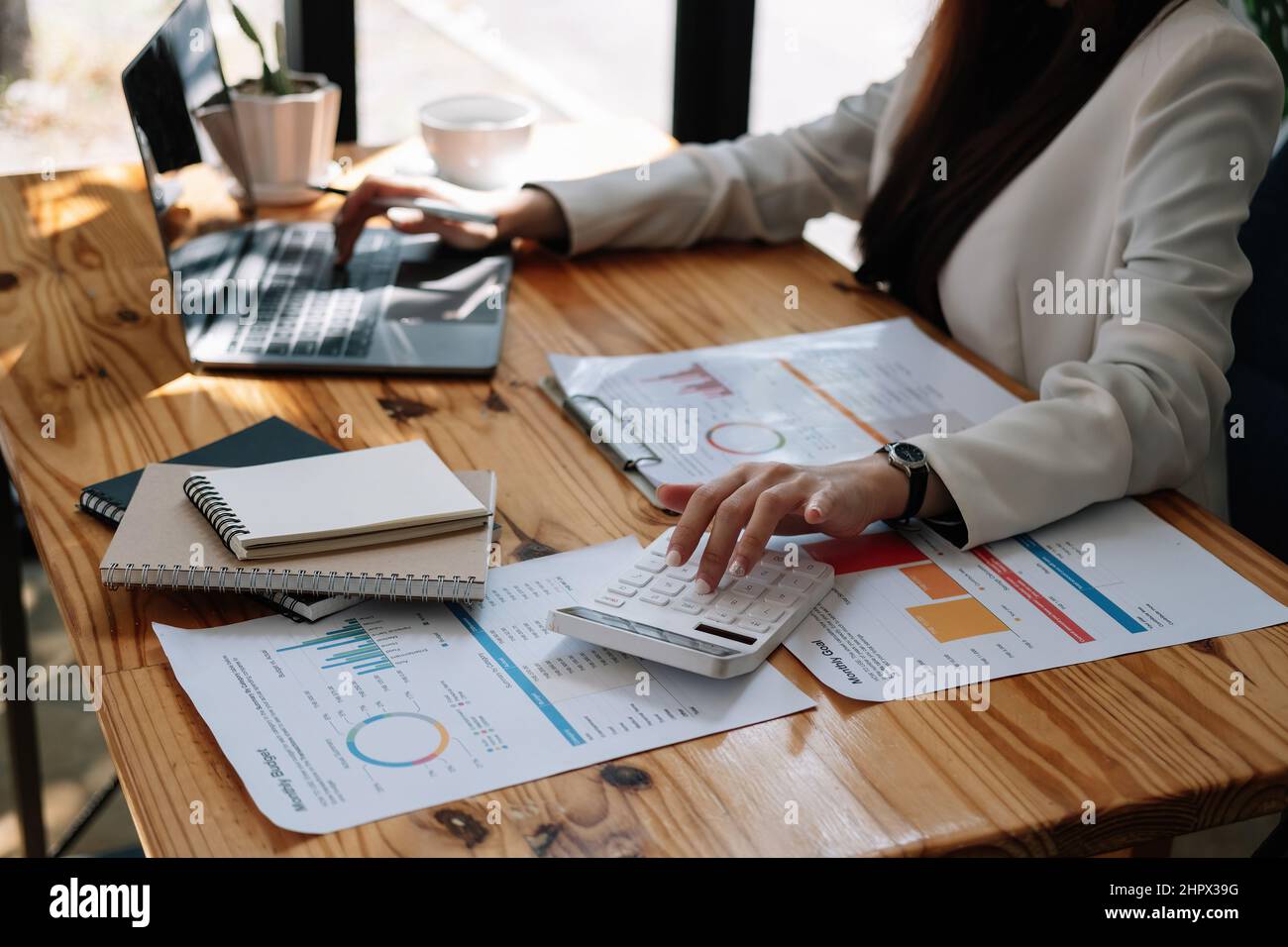 Businesswoman accountant or financial expert analyze business report graph and finance chart at corporate office. Concept of finance economy, banking Stock Photo