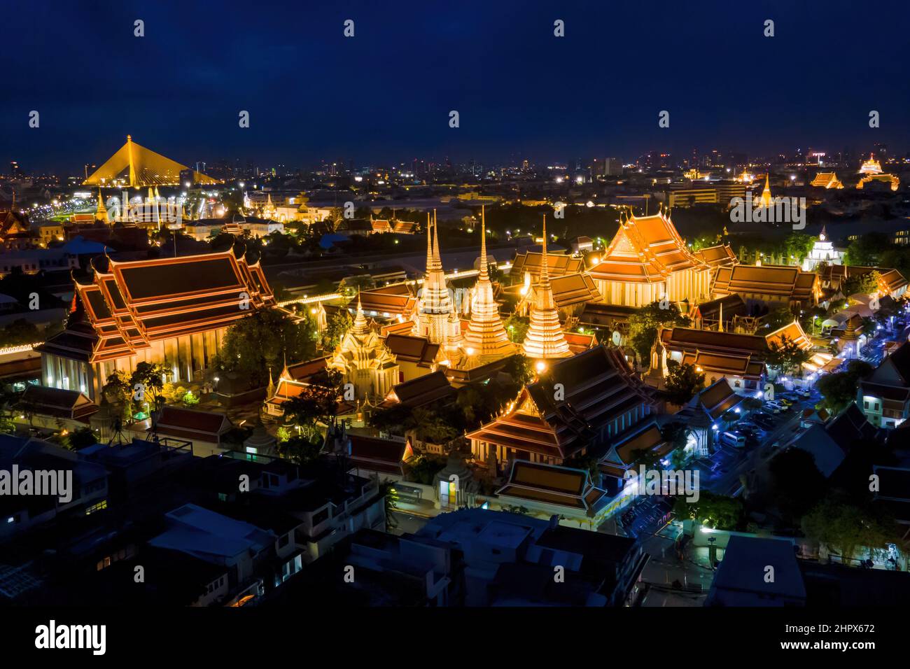 Bangkok, Thailand. 25th July, 2021. (EDITOR'S NOTE: Image taken with drone)Aerial view of the Grand Palace in Bangkok. Two of Thailand's most famous cultural heritage sites and tourist attractions, Wat Arun (Temple of Dawn) and The Grand Palace, are illuminated at night along the Chao Praya River in Bangkok. The Thai Government recently announced eased entry requirements for international tourists visiting Thailand amidst a surge in the Omicron variant of COVID-19 throughout the country, with cases topping 20,000 reported infections per day. Credit: SOPA Images Limited/Alamy Live News Stock Photo