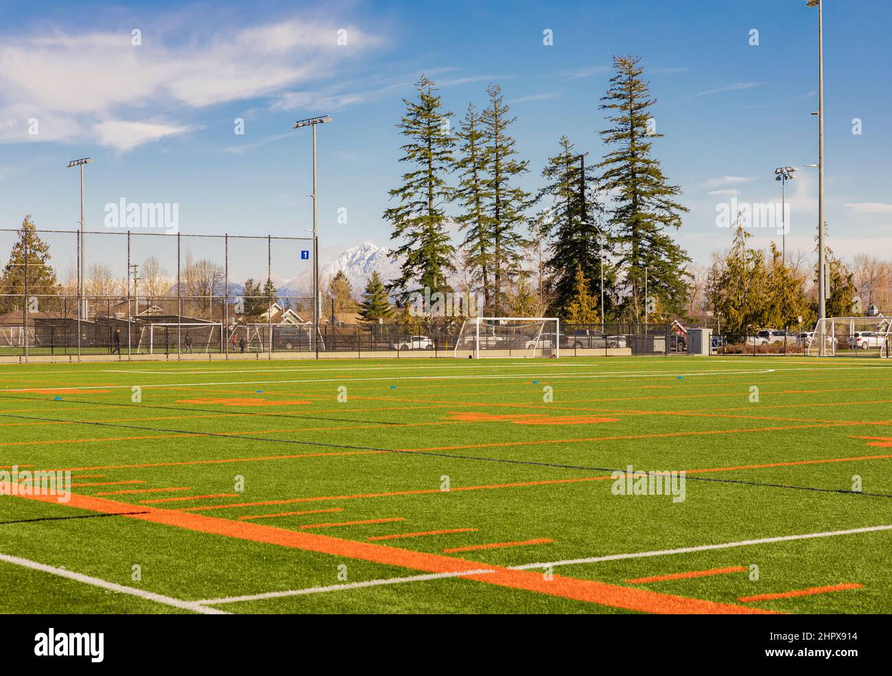 American football and soccer field and grass in sunny spring day. Street view, selective focus Stock Photo