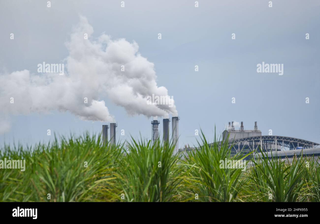 Smoke comes out from chimneys of a power plant hires stock photography