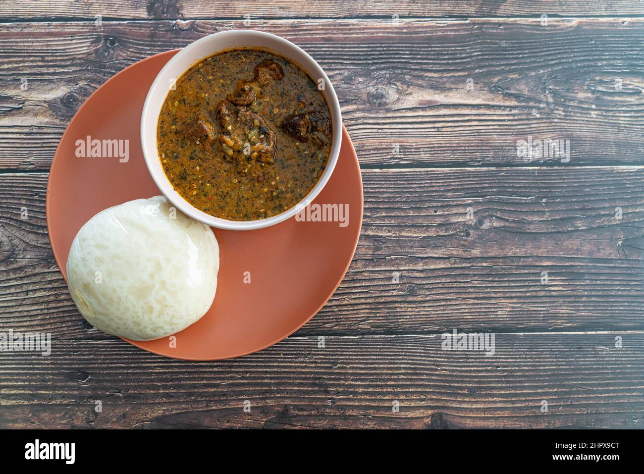 Nigerian Pounded Yam Served with Ogbono Soup ready to eat Stock Photo