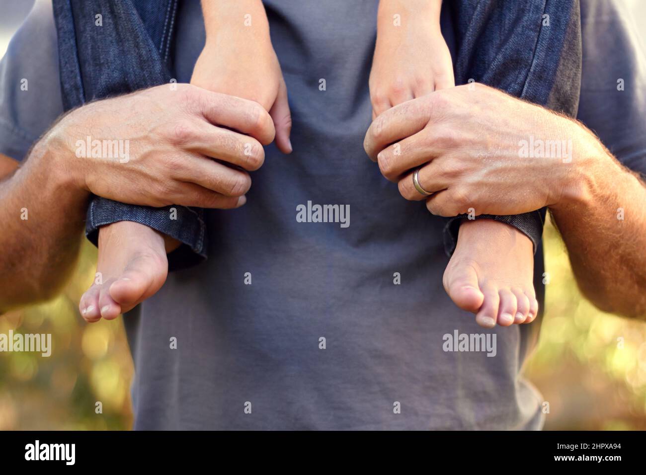 Be there for him always. Closeup shot of a father carrying his son on his shoulders. Stock Photo