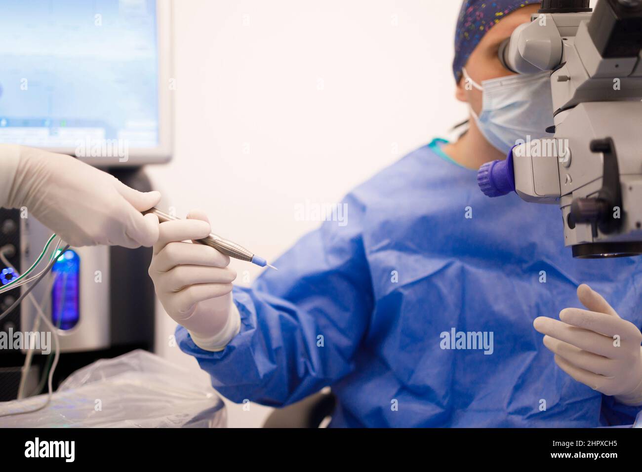 Head nurse assisting a surgeon during his operation Stock Photo