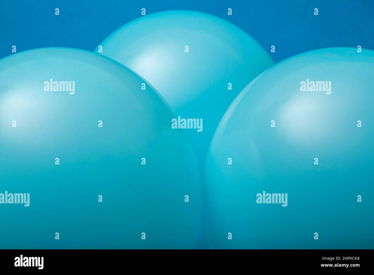 Abstract background of three inflated blue balloons Stock Photo - Alamy