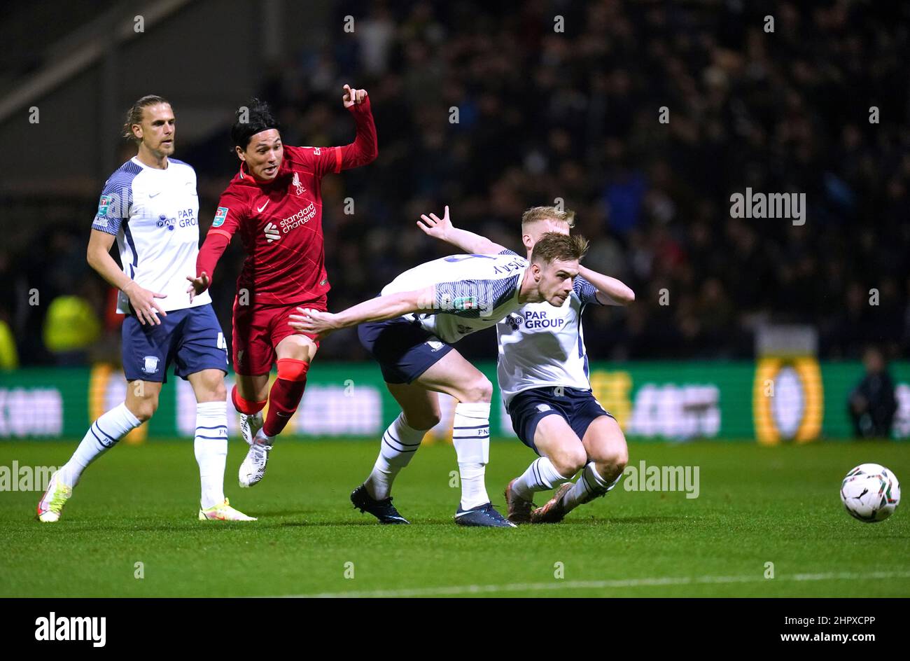File photo dated 27-10-2021 of Liverpool's Takumi Minamino (second left) battles for the ball with Preston North End's Liam Lindsay (second right) and Ali McCann. League Cup specialists Minamino and Origi put their side through after a testing opening hour at Deepdale in which Adrian was the busier of the two goalkeepers. Issue date: Thursday February 24, 2022. Stock Photo