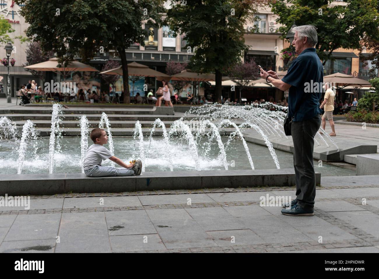 Belgrade, Serbia, Jun 18, 2019: Grandpa photographing grandson Stock Photo