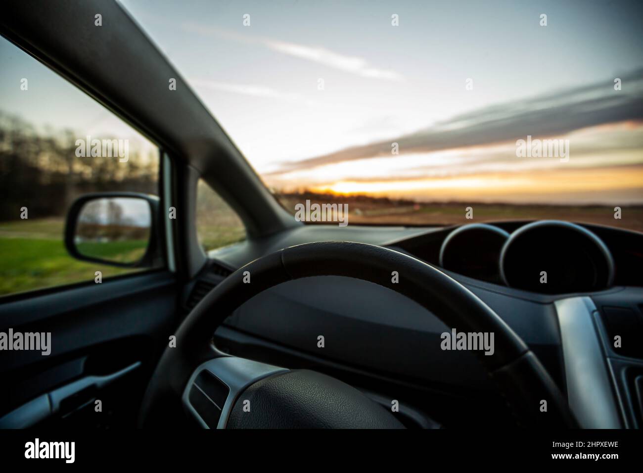 Car steering wheel interior at sunset. Traveling with car concept . Car insurance concept Stock Photo