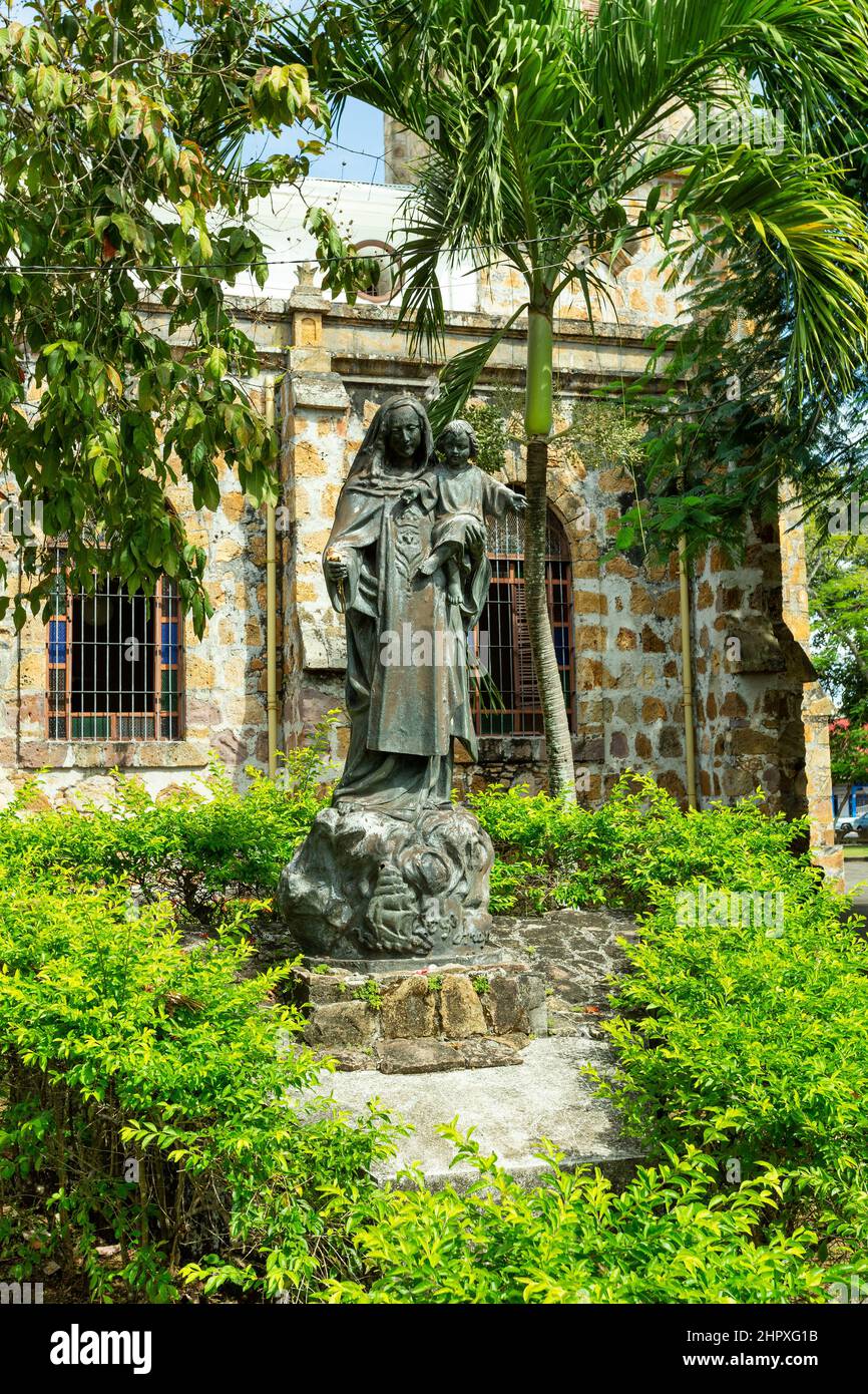 Statue in behind The Our Lady of Mount Carmel Cathedral, Puntarenas Cathedral is a temple of the Roman Catholic church in the city of Puntarenas, Cost Stock Photo