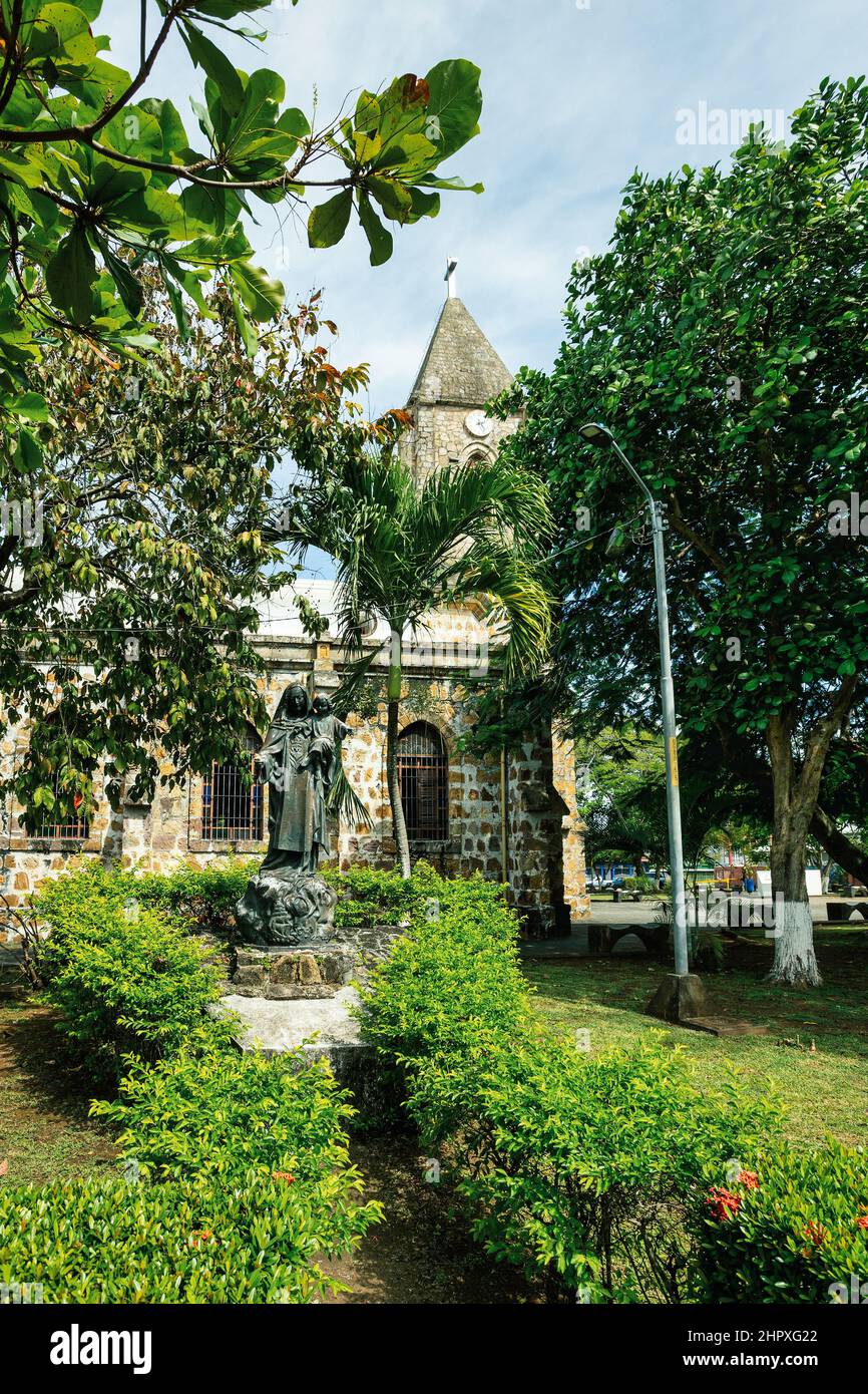 Statue in behind The Our Lady of Mount Carmel Cathedral, Puntarenas Cathedral is a temple of the Roman Catholic church in the city of Puntarenas, Cost Stock Photo