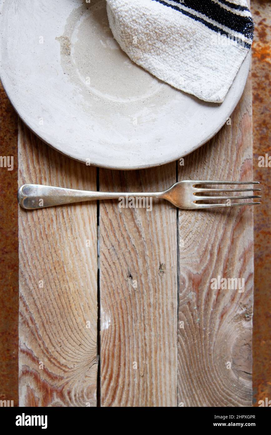 Empty pottery plate on old wooden planks background, copy space, empty place for product, kitchen concept, creative layout, top view, flat layout Stock Photo