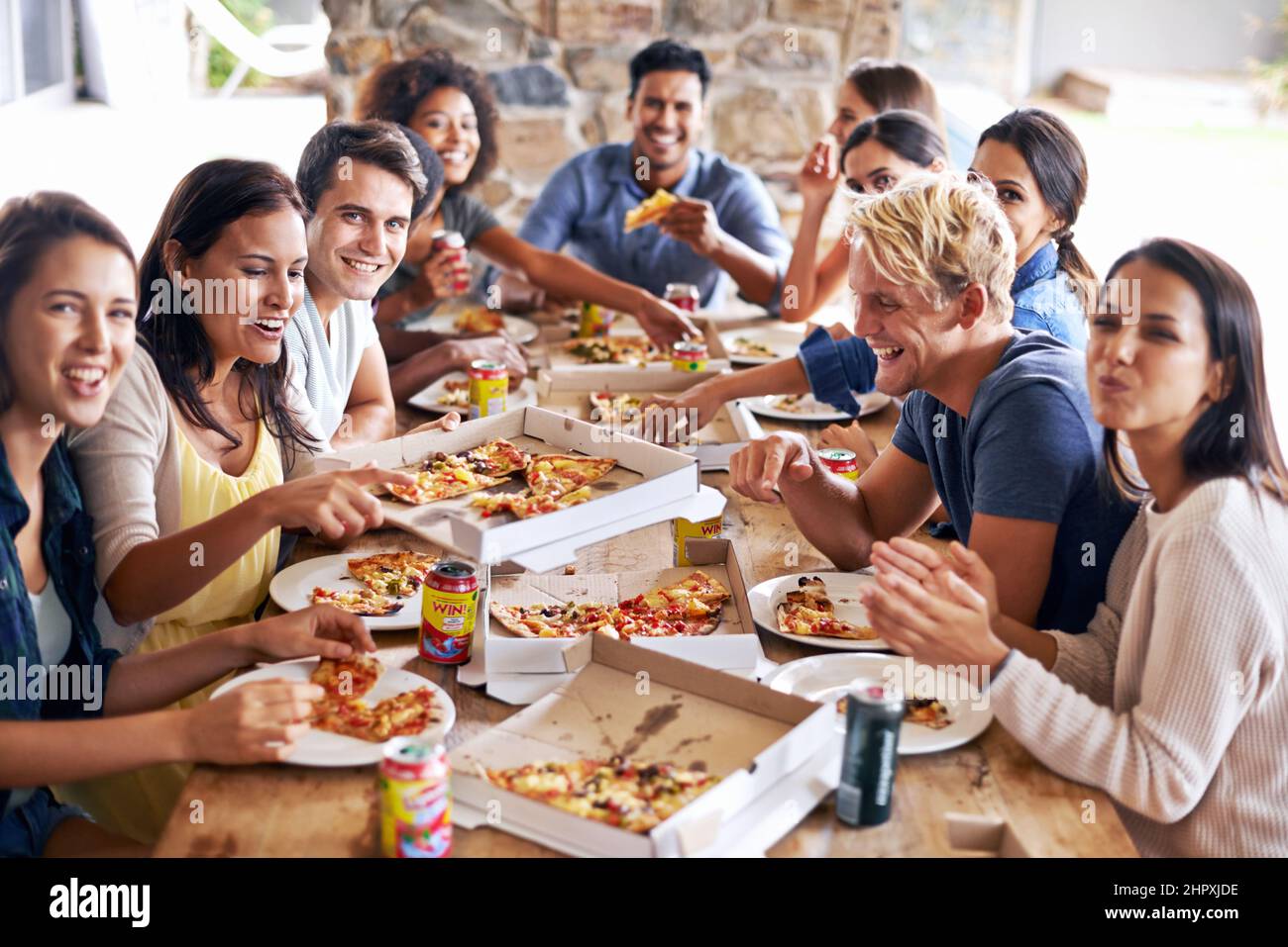 Its time for a pizza party. Cropped shot of a group of friends enjoying pizza together. Stock Photo