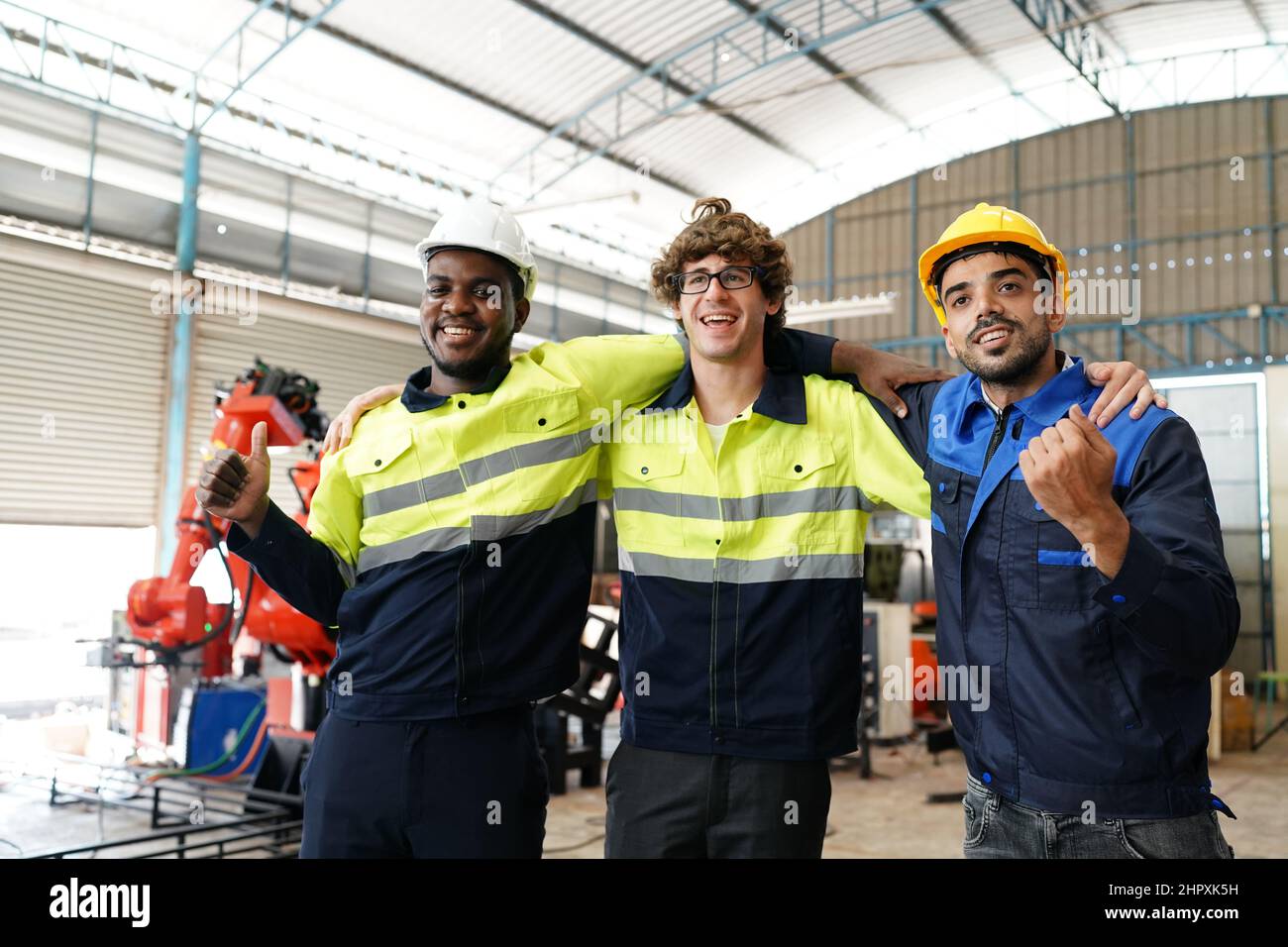 engineer checking control panel and teaching new Automatics robot arm and operating control machine in factory. Stock Photo