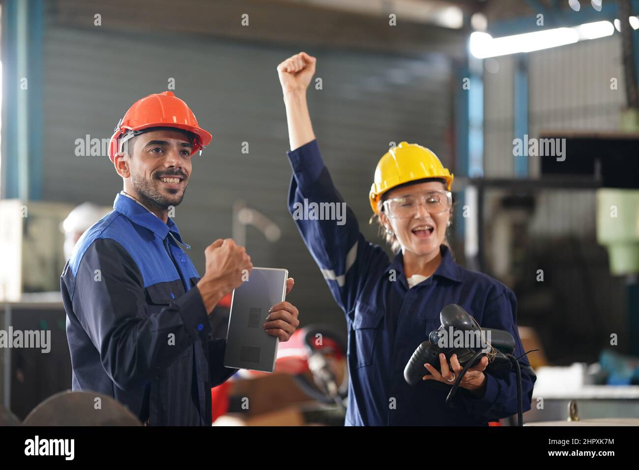 engineer checking control panel and teaching new Automatics robot arm and operating control machine in factory. Stock Photo