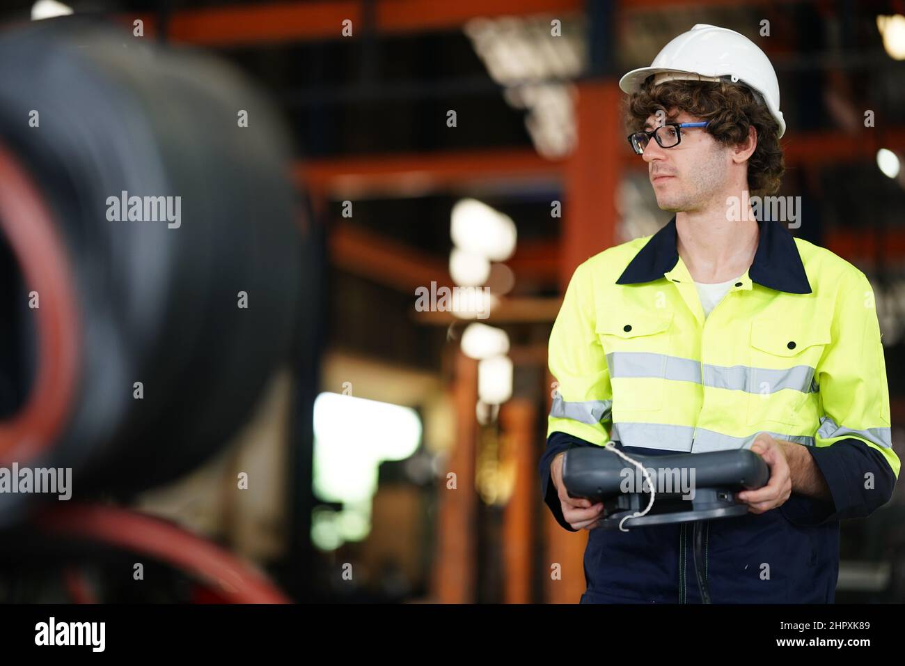 engineer checking control panel and teaching new Automatics robot arm and operating control machine in factory. Stock Photo