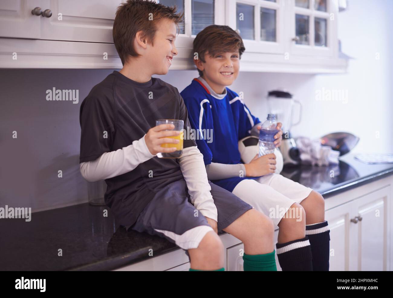 Boys Will Be Boys Cropped Shot Of Two Young Boys Having Cold Drinks After Soccer Practice Stock 3581