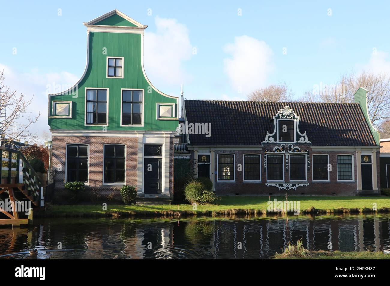 traditional wooden building next to modern factory, industrial heritage in Koog aan de Zaan, the Netherlands, January 2022 Stock Photo