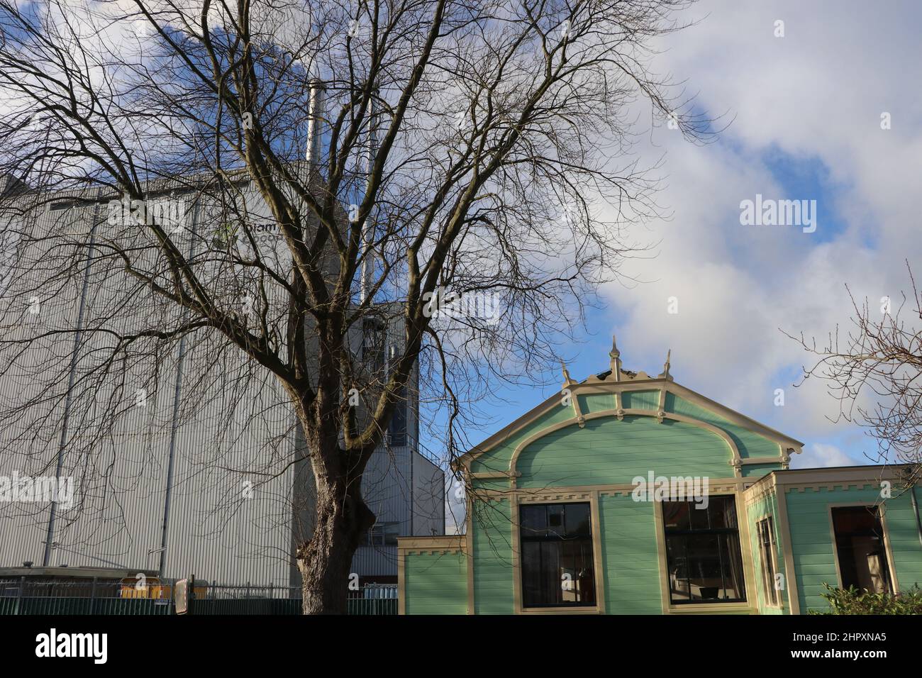 traditional wooden building next to modern factory, industrial heritage in Koog aan de Zaan, the Netherlands, January 2022 Stock Photo