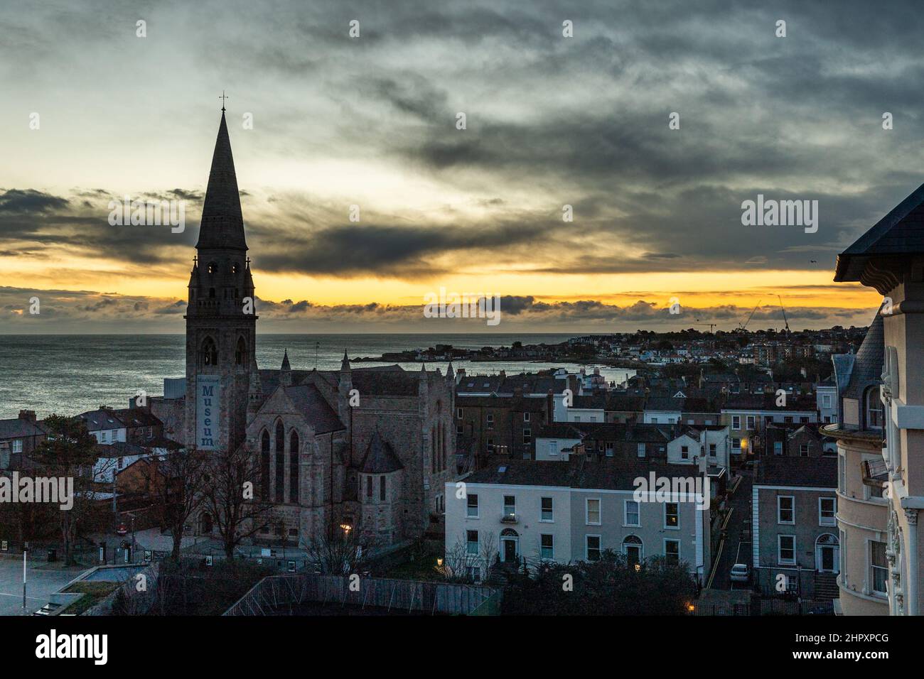 Dun Laoghaire, Ireland. 24th Feb, 2022. The sun starts to rise over Dun Laoghaire shortly before a flurry of snow fell. More wintry showers are expected throughout the day. Credit: AG News/Alamy Live News Stock Photo