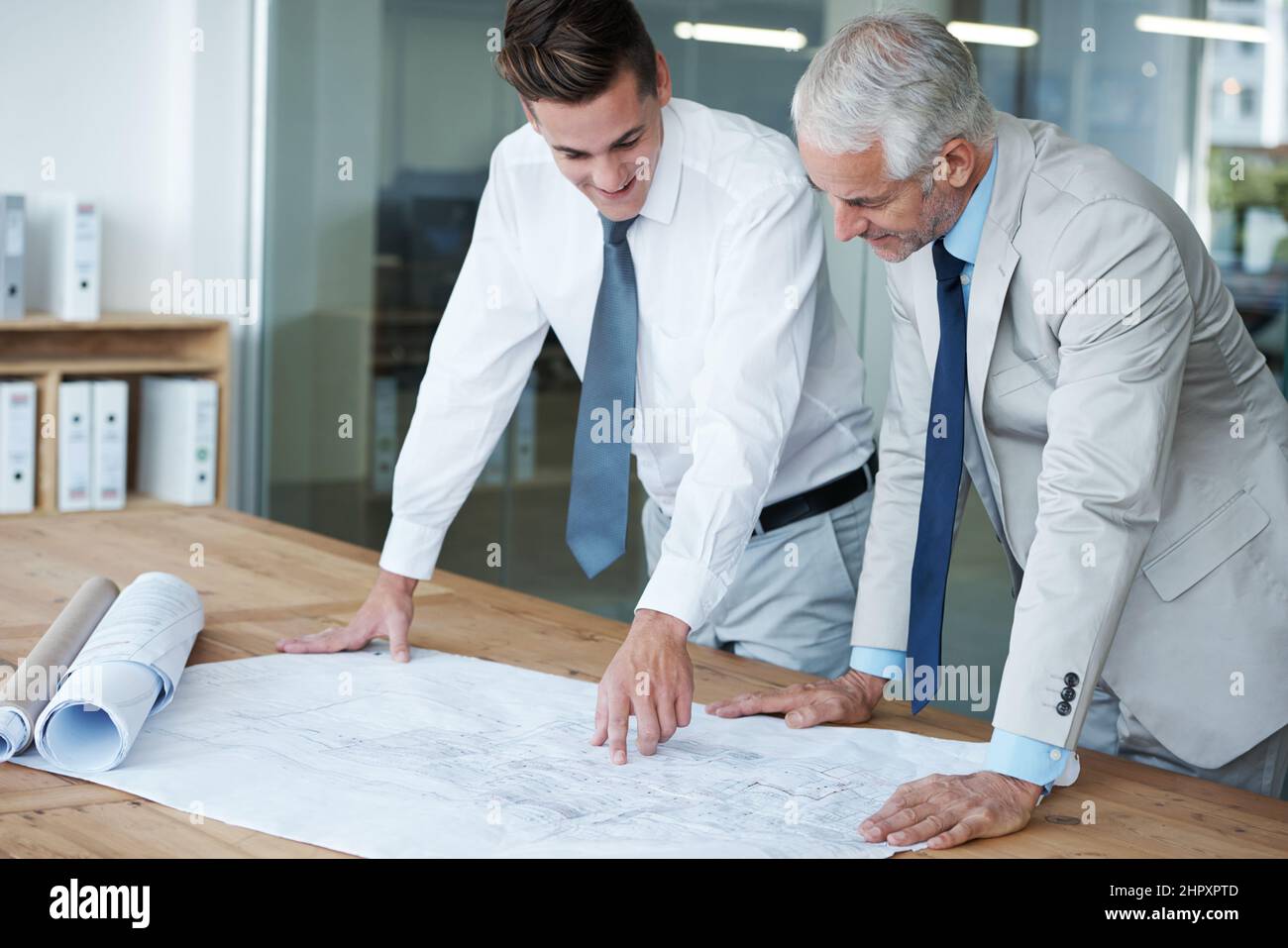 Ensuring the blueprints are perfect. Two corporate architects going ...