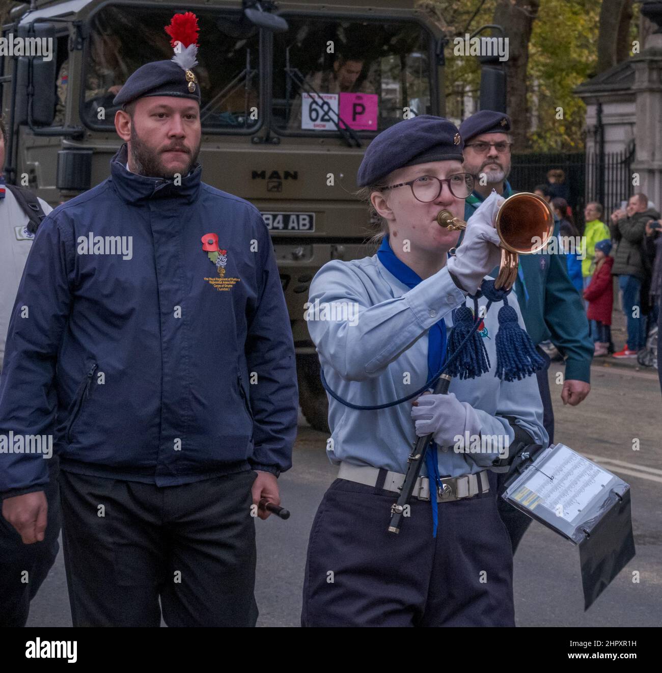 Female blows a bugle while marching with the Corps of Drums Society at the Lord Mayor’s Show 2021, Victoria Embankment, London, England, UK. Stock Photo