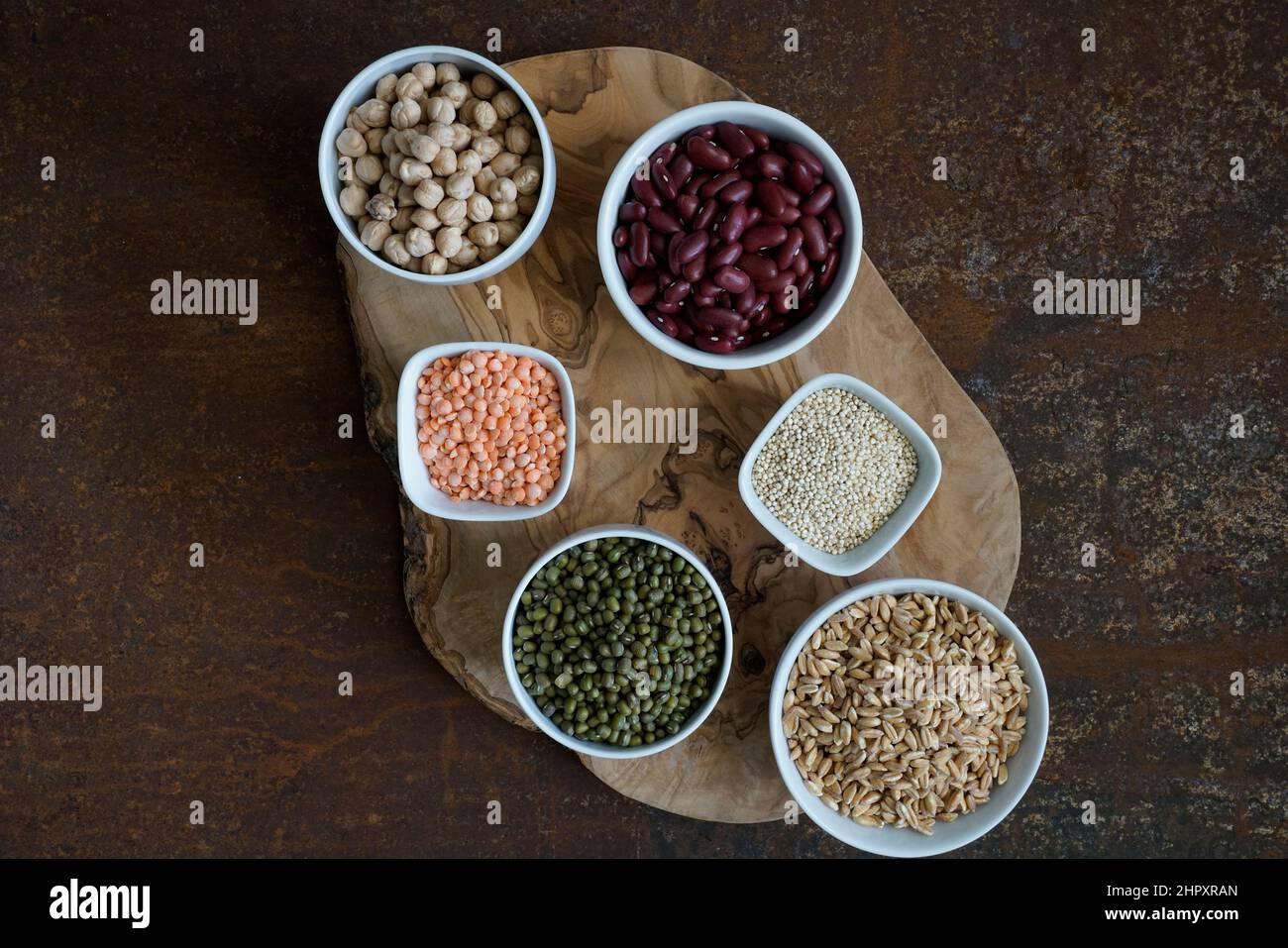 Variety of uncooked superfood cereals, chia, red lentils, pearl spelled