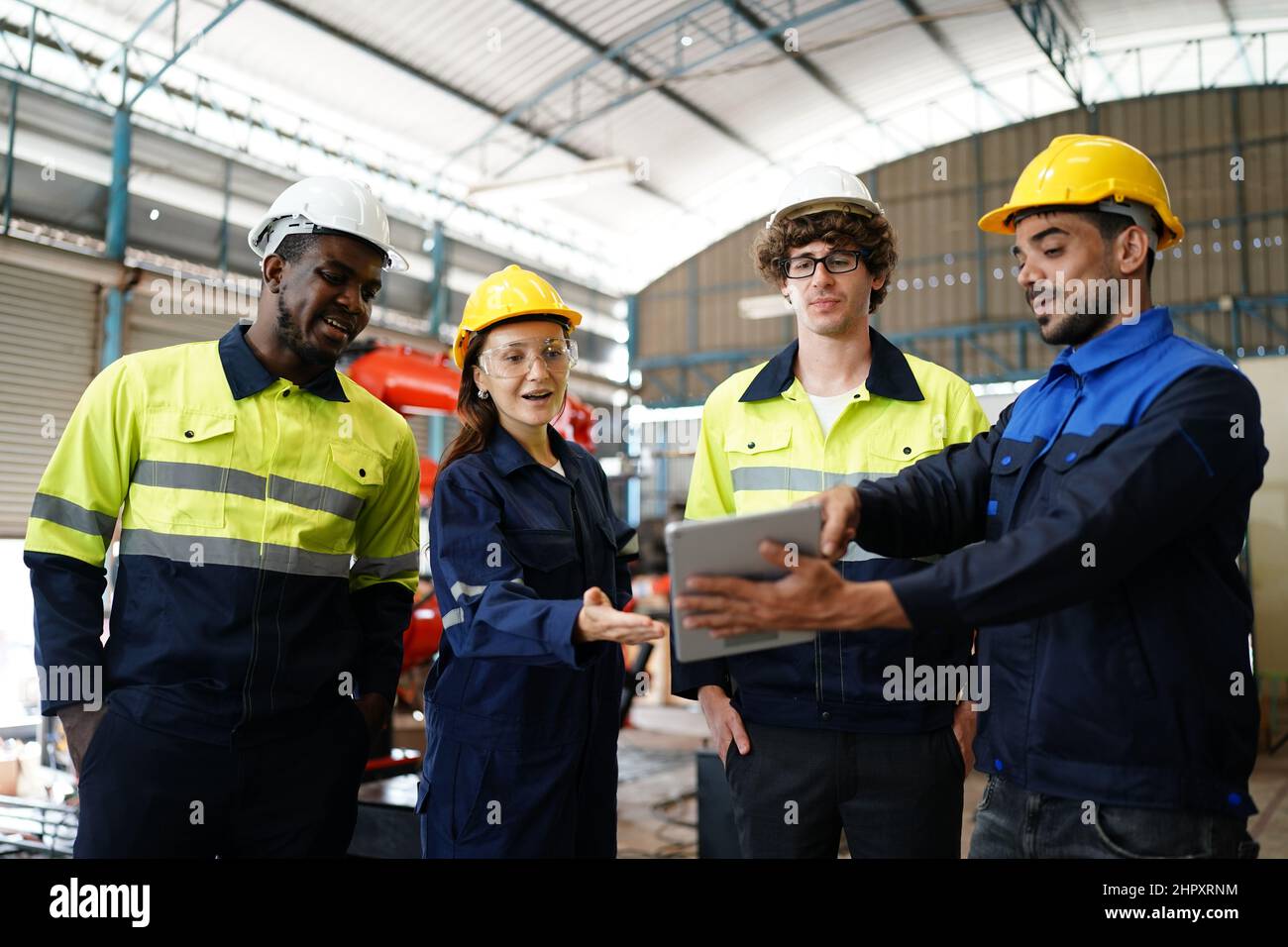 engineer checking control panel and teaching new Automatics robot arm and operating control machine in factory. Stock Photo
