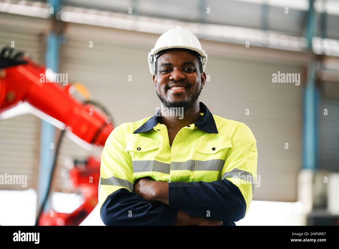 engineer checking control panel and teaching new Automatics robot arm and operating control machine in factory. Stock Photo