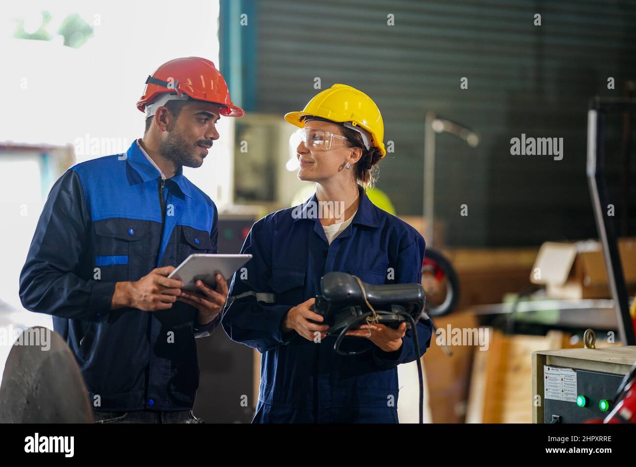engineer checking control panel and teaching new Automatics robot arm and operating control machine in factory. Stock Photo