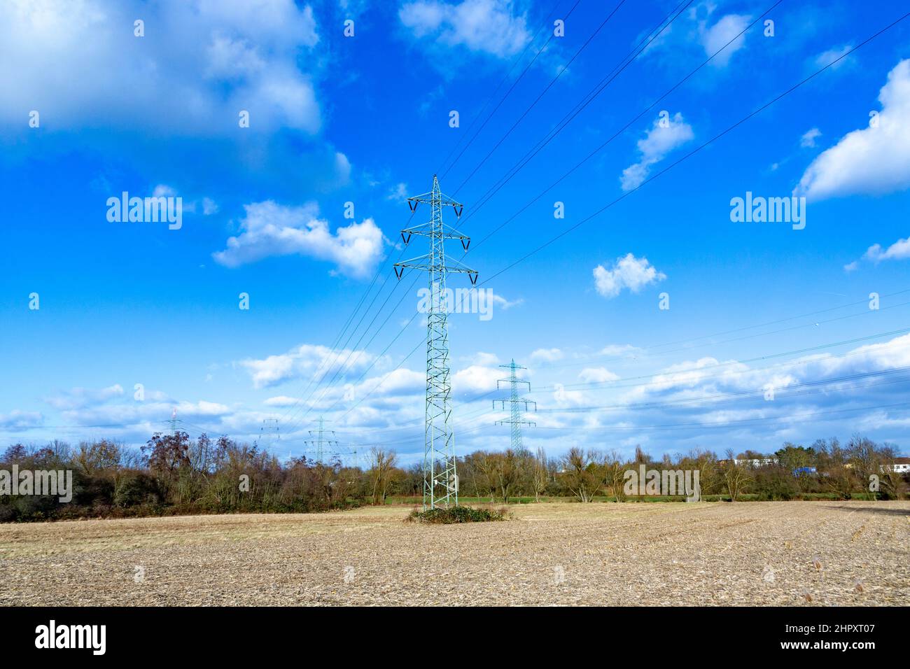 view of electric pylon under clear blue sky Stock Photo - Alamy
