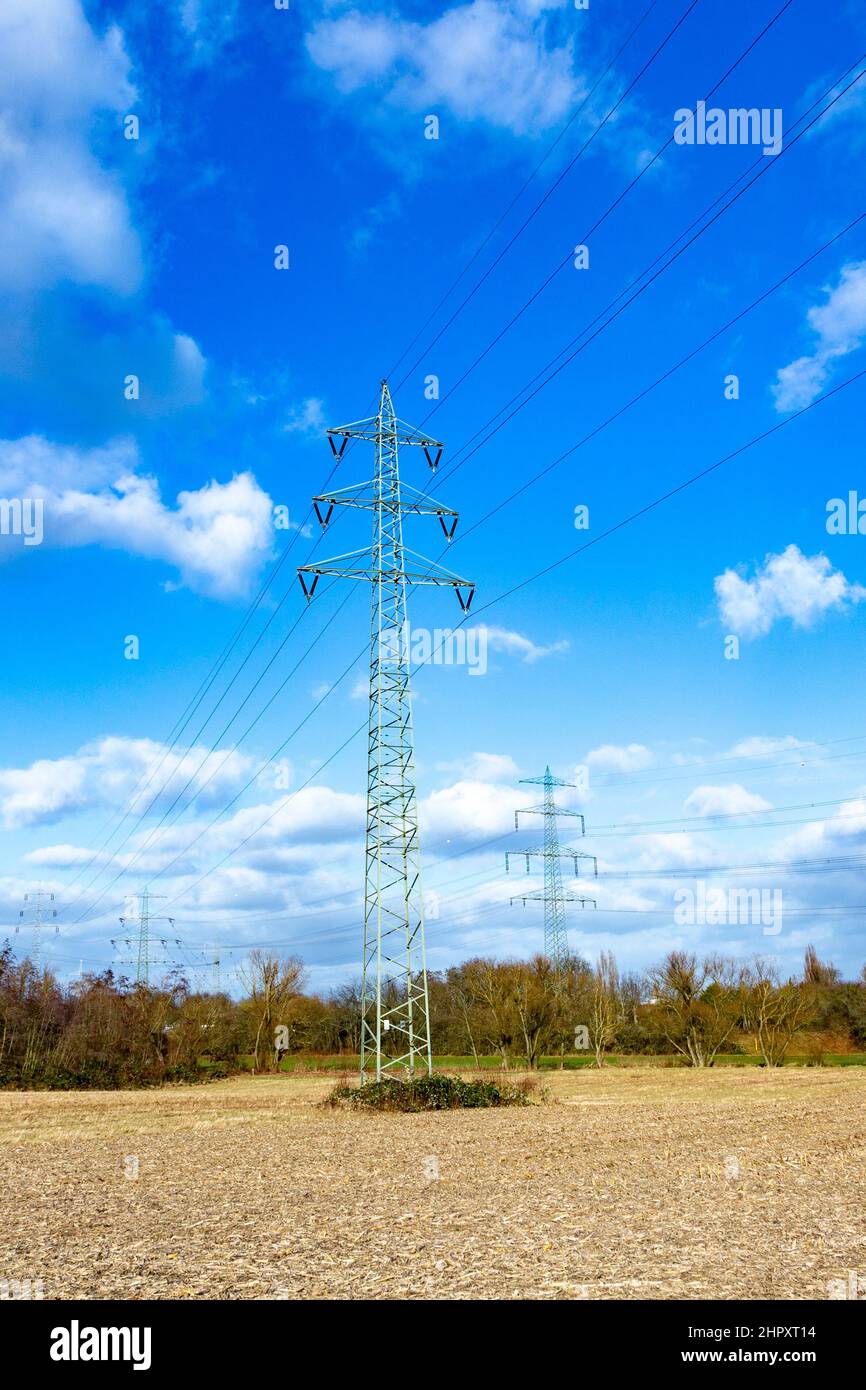 view of electric pylon under clear blue sky Stock Photo - Alamy