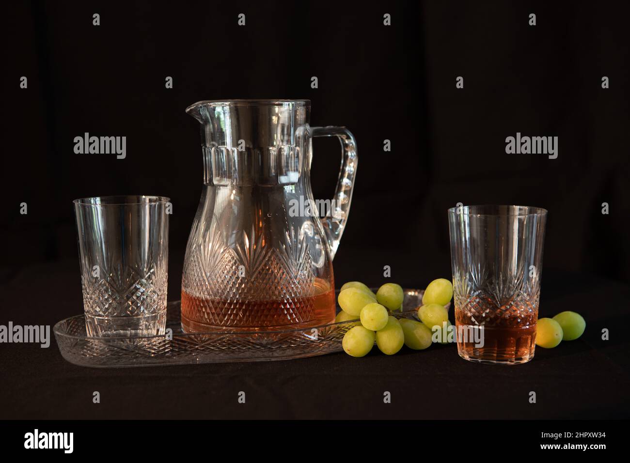 crystal carafe with glasses on a tray, Still life, low key image Stock Photo