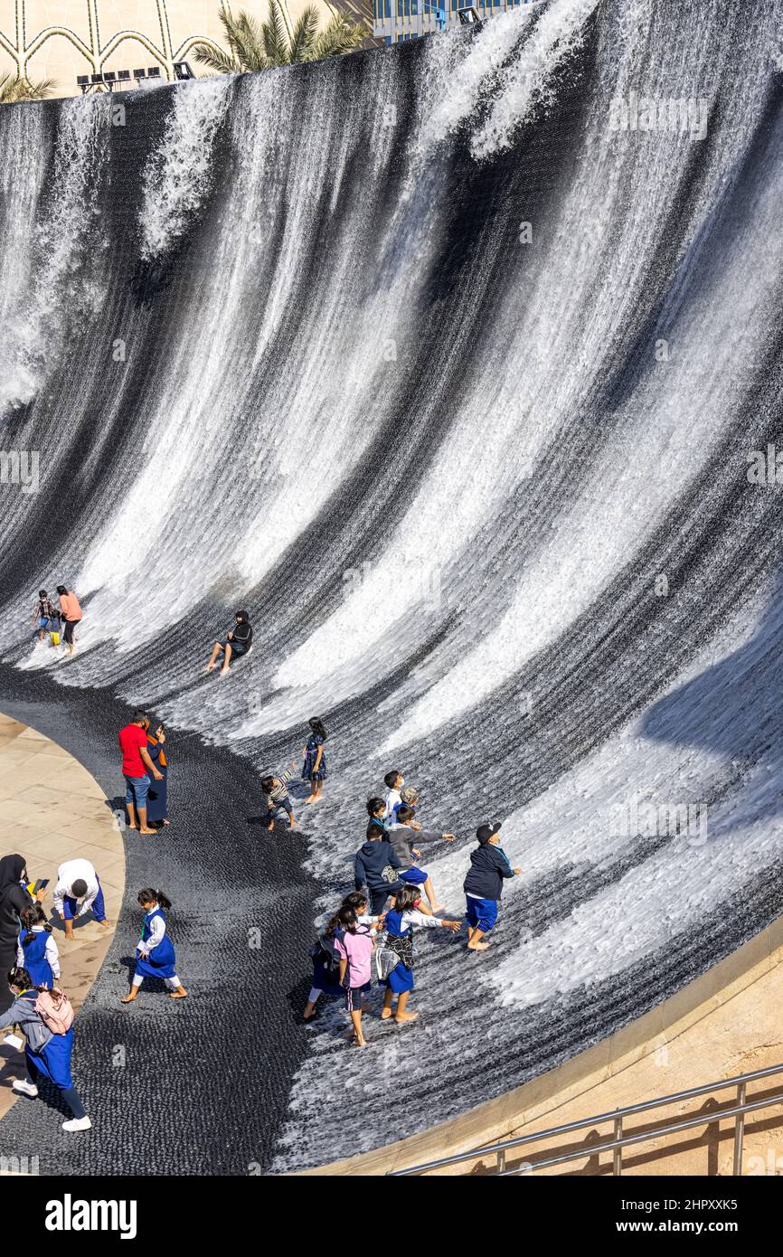 Visitors enjoying the surreal water feature in Jubilee Park at Dubai