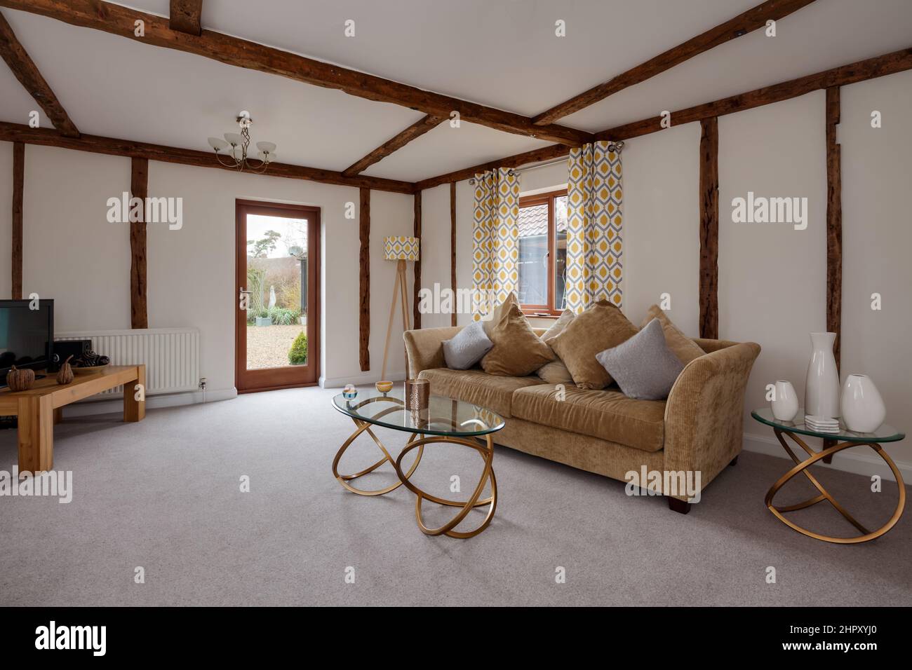 Beautiful luxury furnished sitting room within traditional old property with exposed timbers decorated to provide a bright living space with contempor Stock Photo
