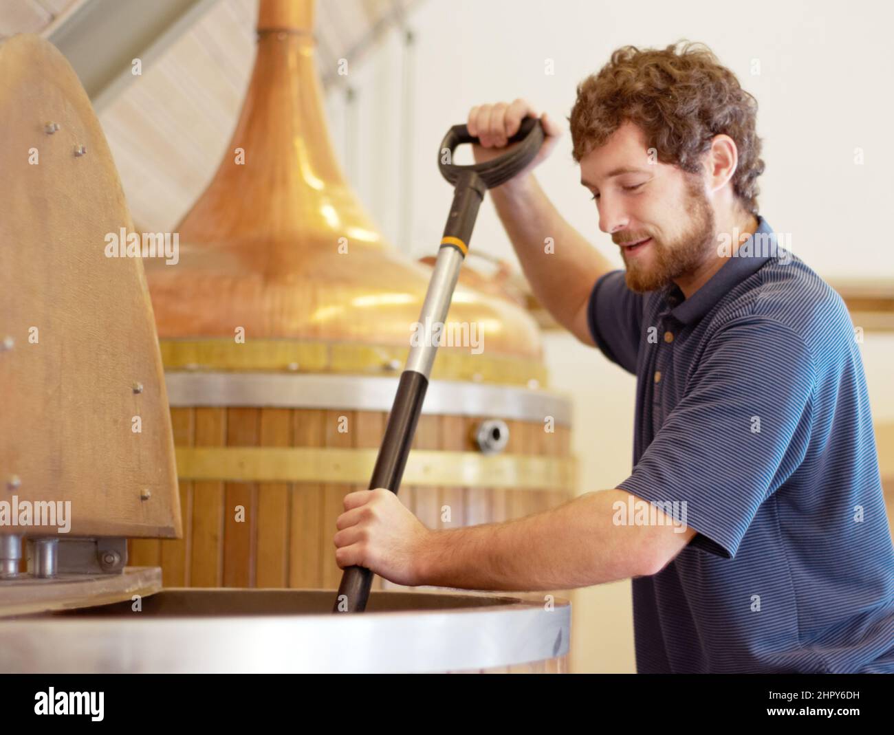 Brewing the best. Shot of a young man working on a batch of beer in a brewery. Stock Photo