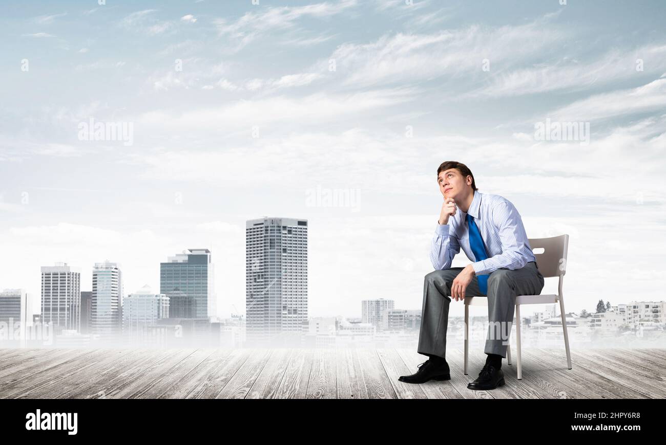 Young businessman sitting on an office chair Stock Photo - Alamy