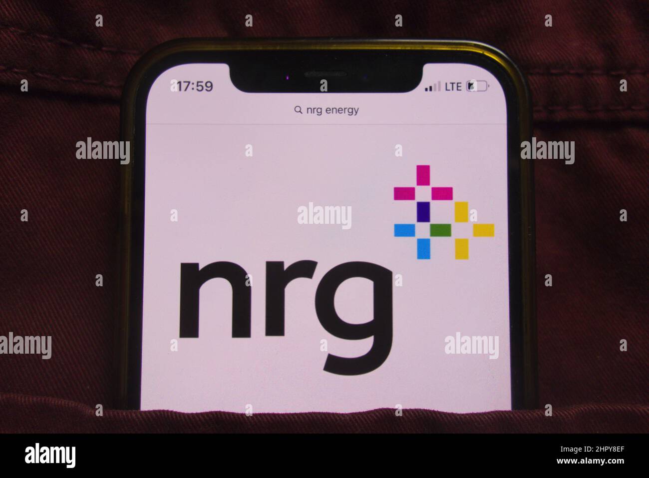 KONSKIE, POLAND - February 22, 2022: NRG Energy Inc logo displayed on mobile phone hidden in jeans pocket Stock Photo