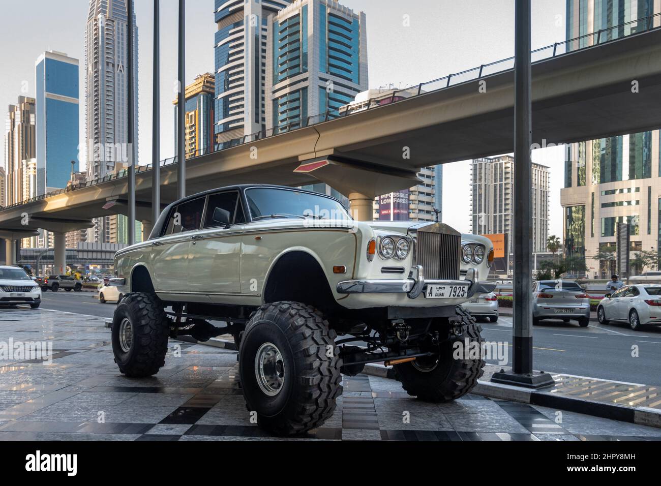 Custom Rolls Royce Silver Shadow II parked near the Sheikh Zayed Road, with the metro line close by Dubai, United Arab Emirates (UAE). Stock Photo