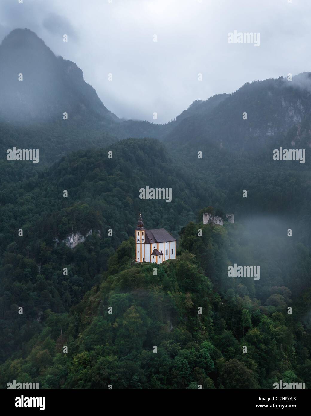 Church on a peak with dense trees on a misty day in Alps, Bavaria Stock ...