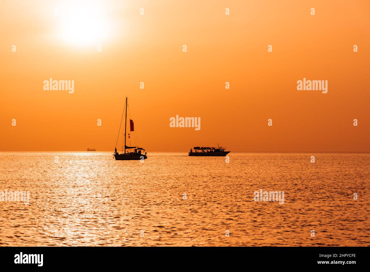 Silhouette of sailing boats on the sunset Stock Photo - Alamy