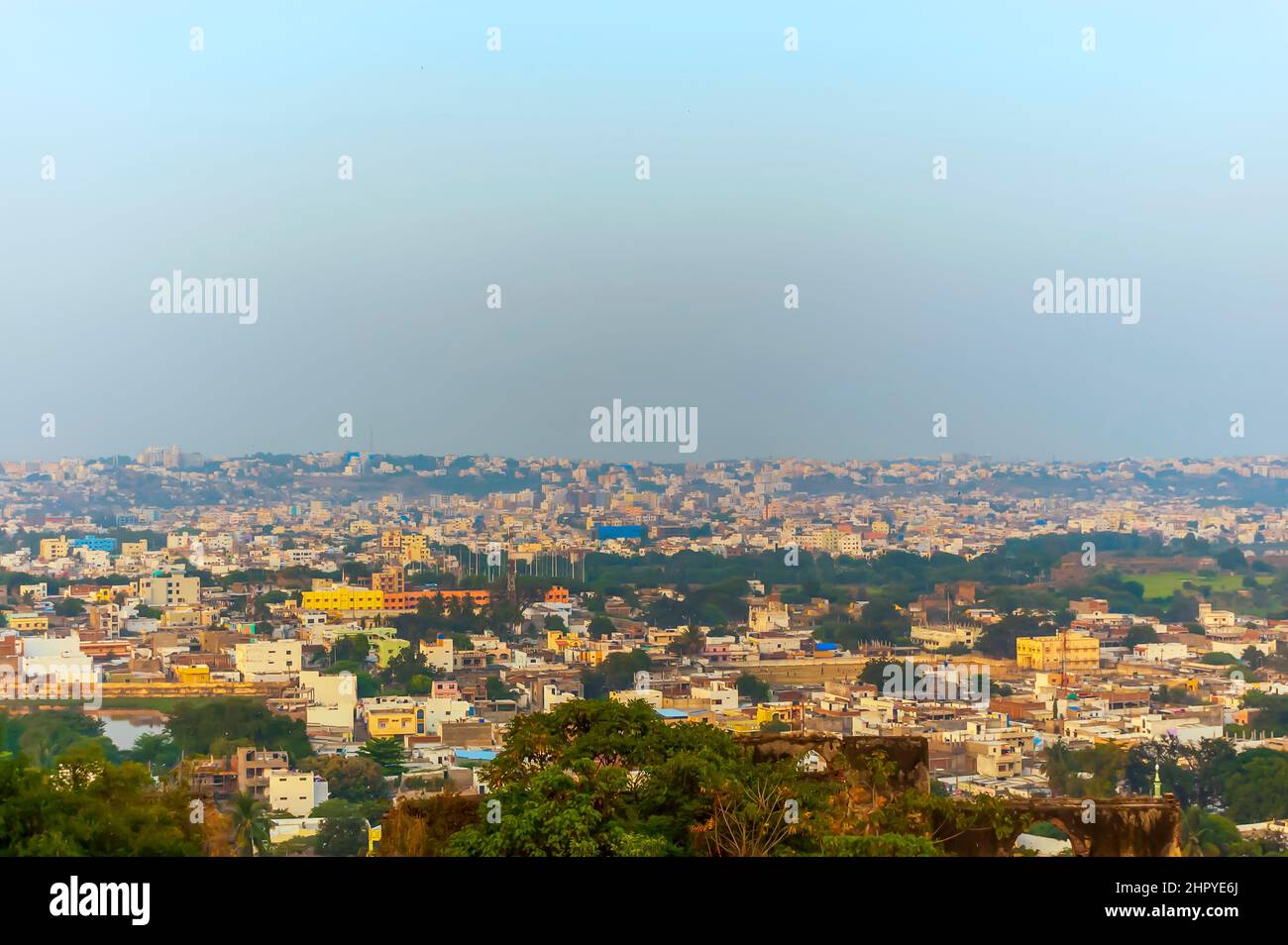 A view of the Hyderabad city, Telangana, India, from atop the Golconda fort. A thin layer of smog can be seen pervading the city's skyline. Stock Photo