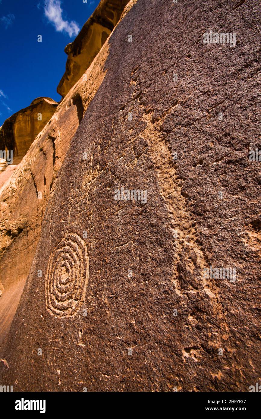 A spiral and man figure, part of the Bighorn Sheep Panel, a petroglyph rock art panel in Seven Mile Canyon, Moab, Utah. Stock Photo