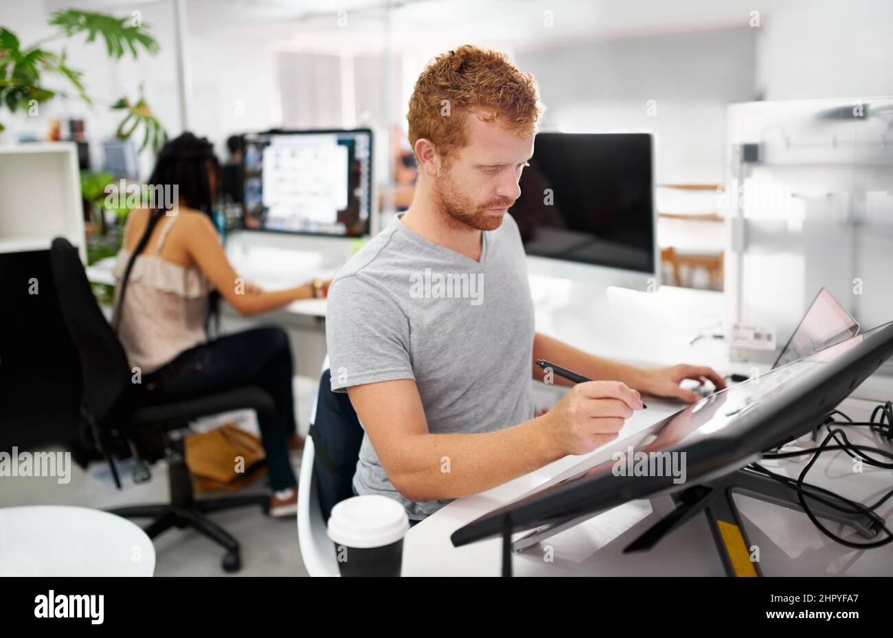 Smart technology makes everything easier. A young man working on a large touchscreen. Stock Photo