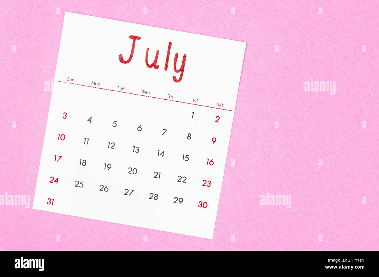 The July 2022 calendar on pink background with empty space. Stock Photo