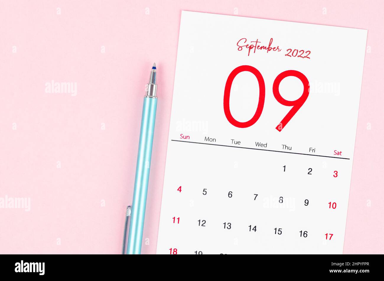 The September 2022 calendar with pen on pink background. Stock Photo