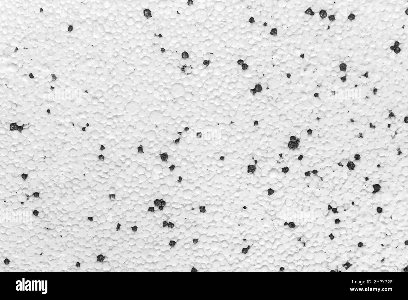 Styrofoam Polystyrene Plasterboard Drywall Foam Building Material Surface White With Abstract Black Pattern Dots Wall Texture Background. Stock Photo