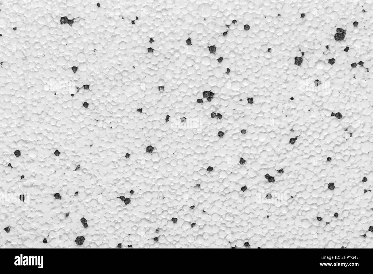 Styrofoam Polystyrene Plasterboard Drywall Foam Building Material Surface White With Abstract Black Pattern Dots Wall Texture Background. Stock Photo