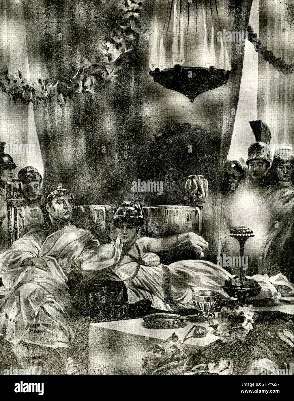 This 1912 images shows Cleopatra dropping a pearl into a golblet of wine. The Roman writer Pliny the Elder, in his Natural History, told of Cleopatra betting Marc Antony that she could host the most expensive dinner in history. To impress Antony and the Roman Empire he represented with the extent of Egypt’s wealth., she crushed one large pearl from a pair of earrings and dissolved it in a goblet of wine (or vinegar), before gulping it down (the subject of this illustration.) Cleopatra VII (69-30 B.C.), the daughter of Ptolemy XI, of Egypt. She married her brother Ptolemy XII and began to rule Stock Photo